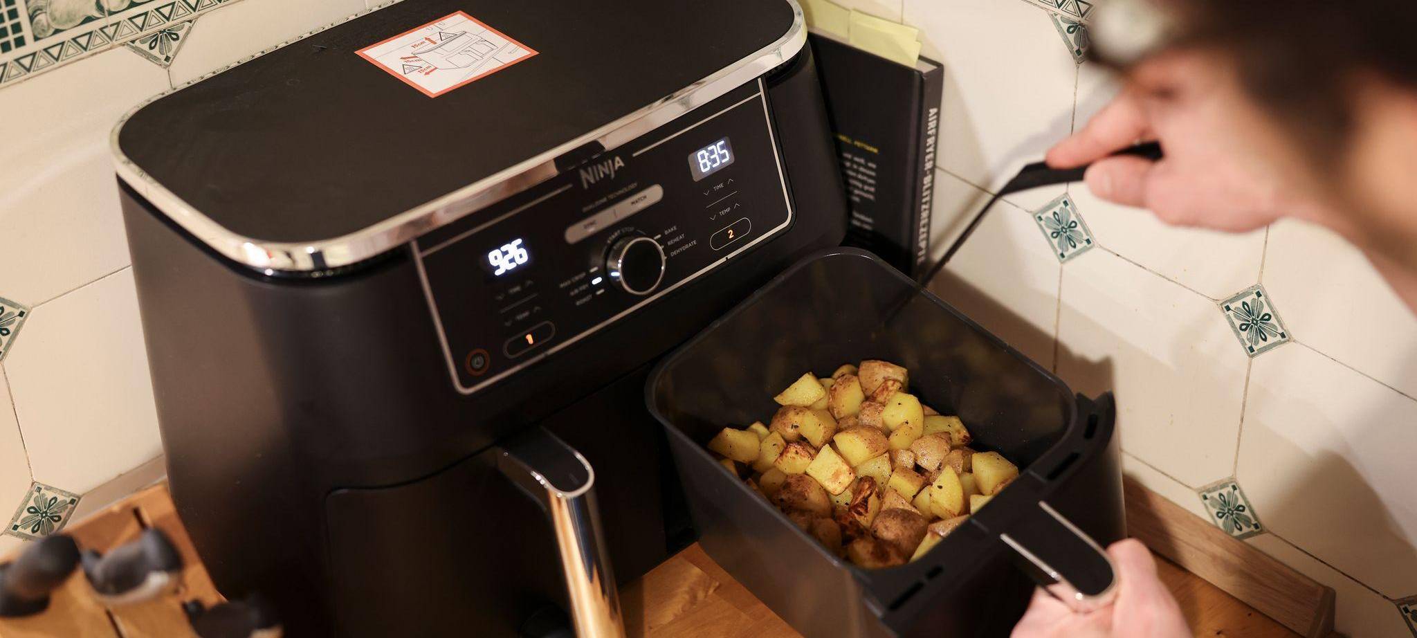 Mann kocht mit einem Airfryer